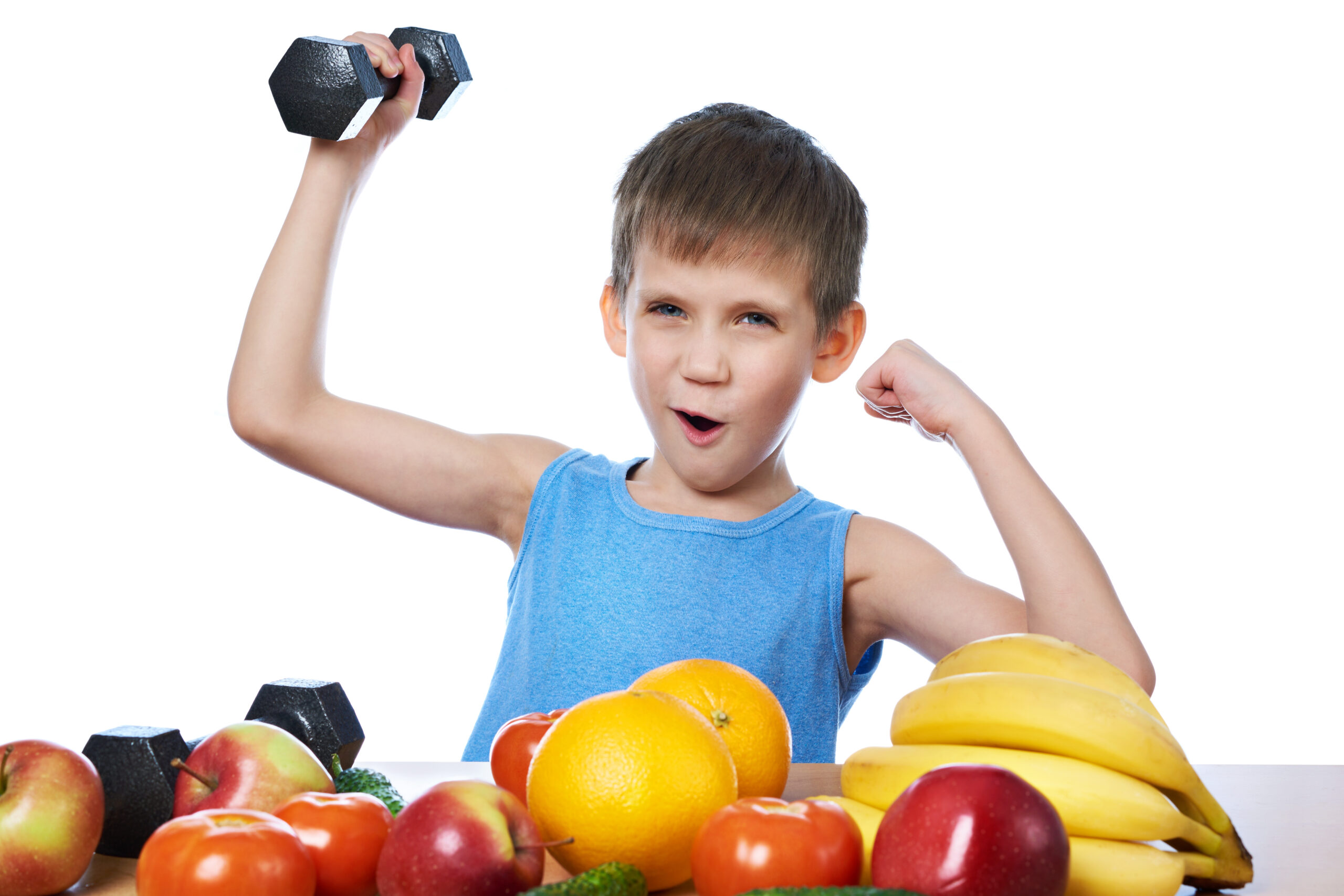 Healthy sporty boy with fruits, vegetables and dumbbells isolate
